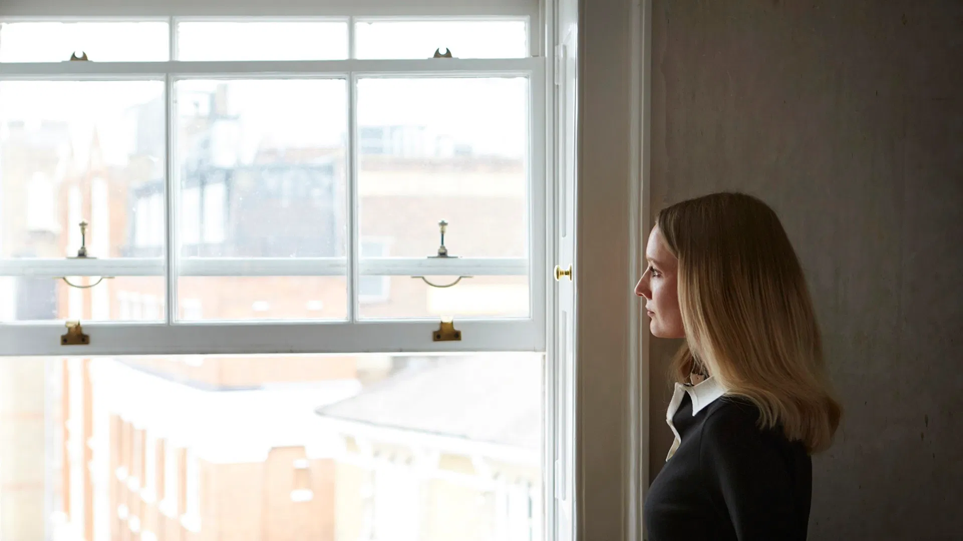 A Phoenix Studios team member standing beside a studio window in London.